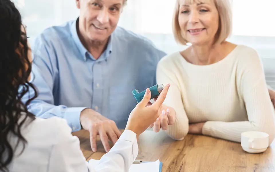 Older couple receiving inhaler