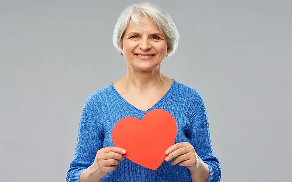 Woman holding heart shaped paper