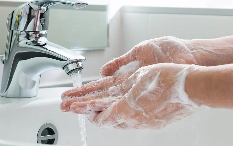 closeup of hand washing at sink