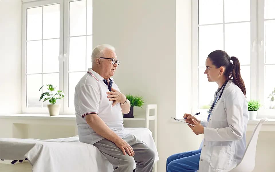 Senior man receiving a health screening from a doctor