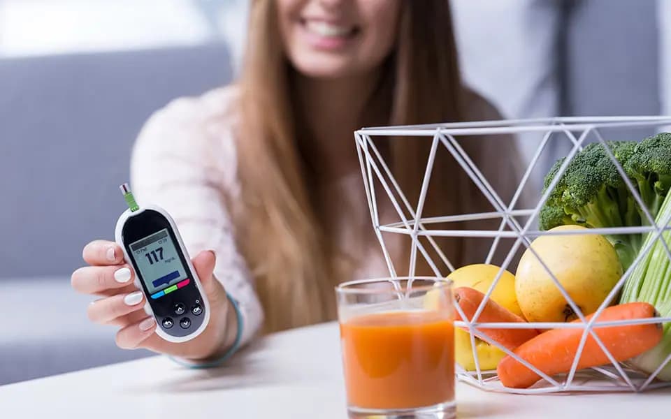 Woman showing blood sugar next to healthy food items