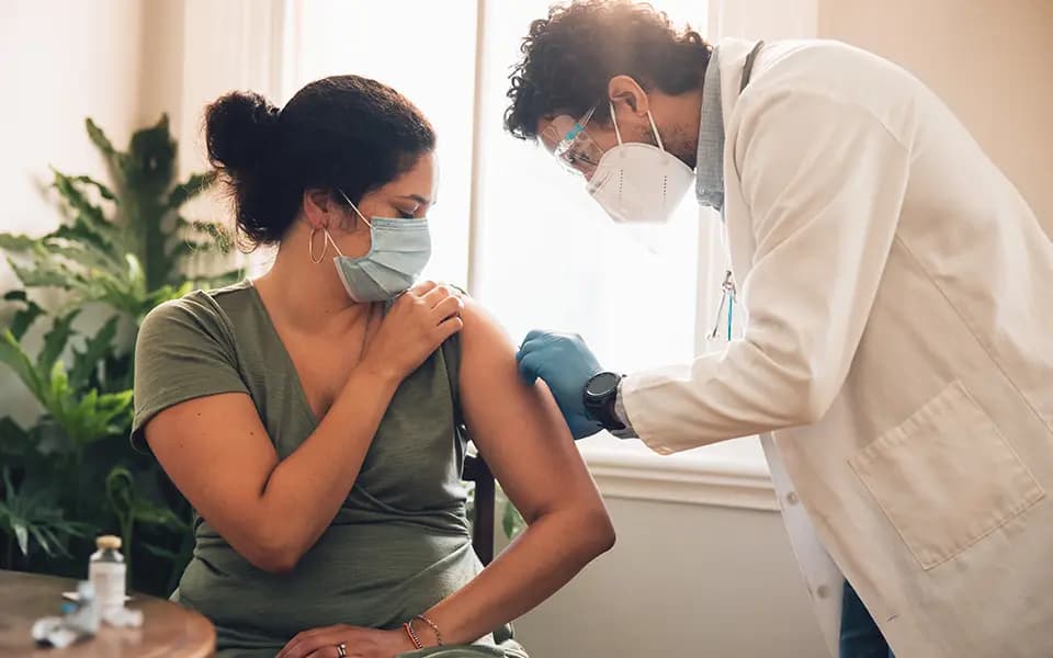 Woman getting vaccination at home