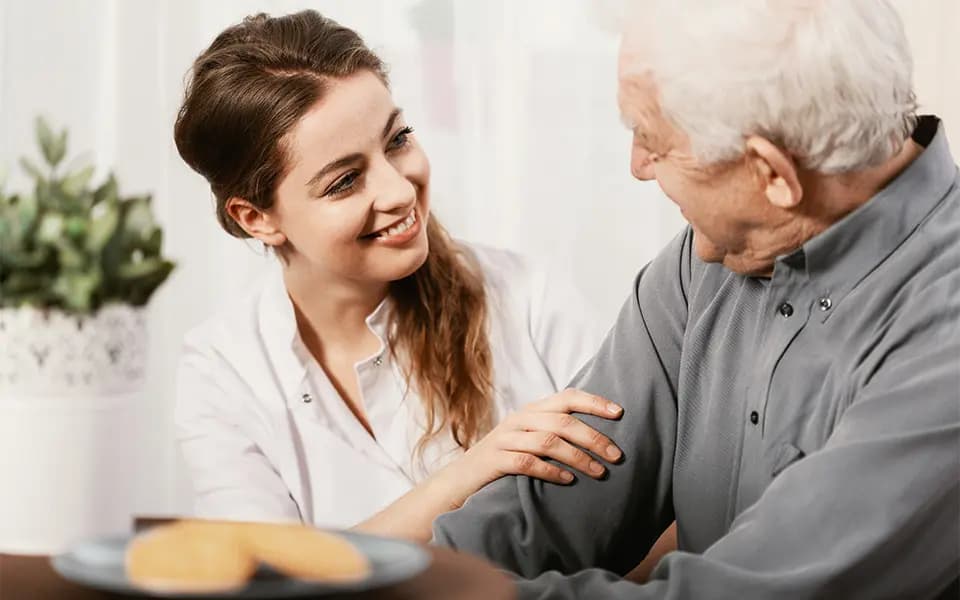 Patient and worker smiling