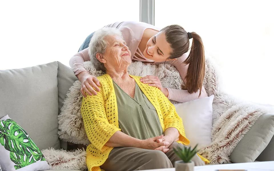 Older woman being consoled by grand child