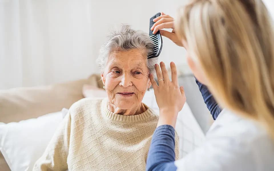 Woman combing patients hair