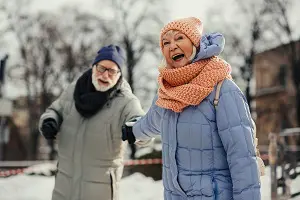 Excited aged woman pulling hand