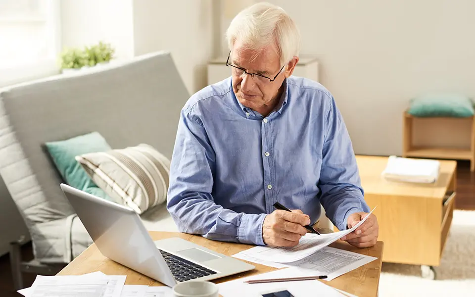 senior man doing paperwork