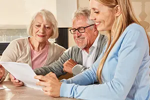 senior discussing paperwork with wife and child