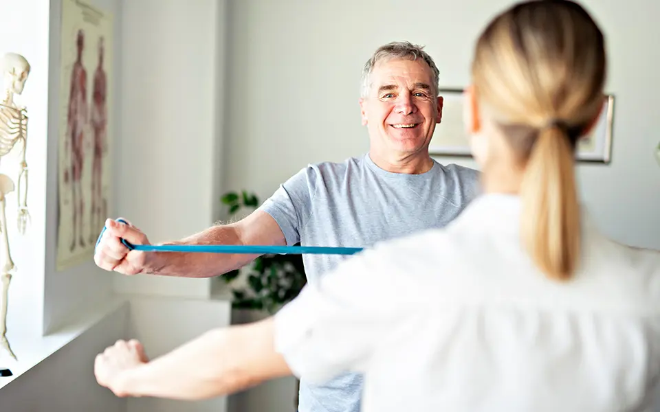 A Modern rehabilitation physiotherapy worker with senior client
