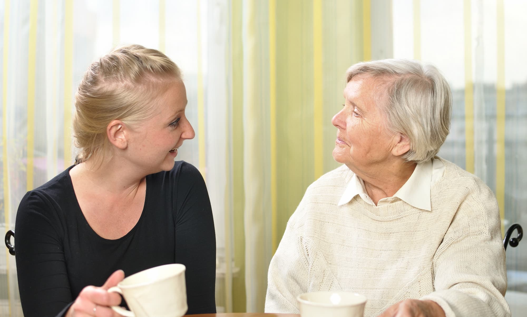 Senior woman with her granddaughter talk to each other.