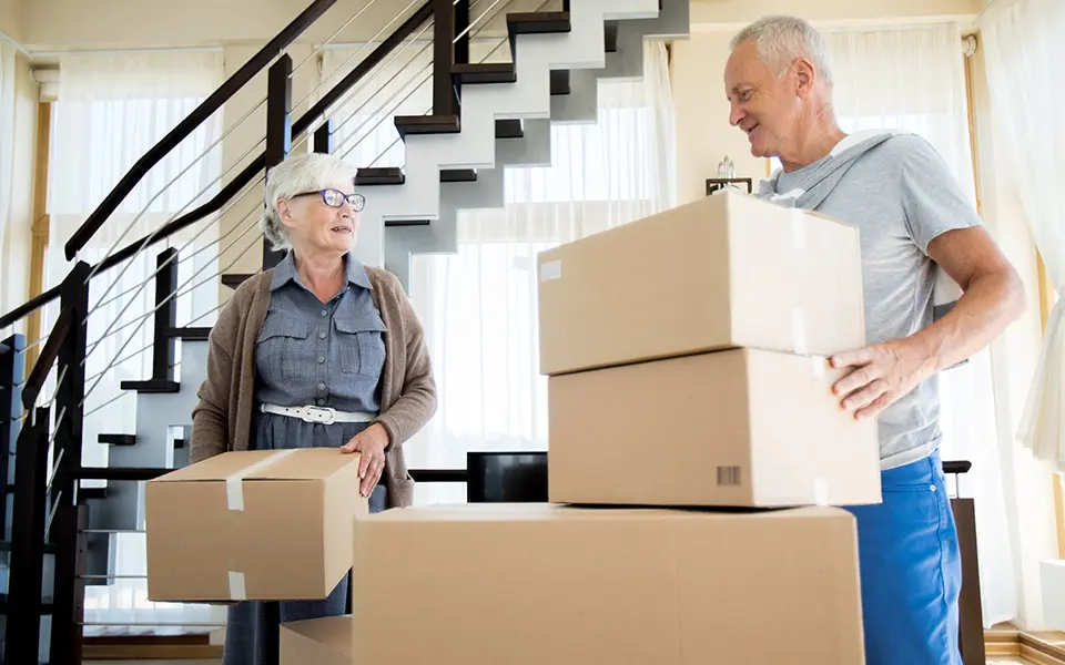senior couple packing boxes