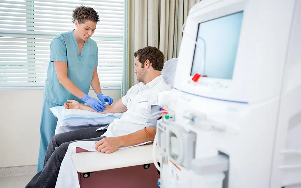 Nurse Injecting Patient For Renal Dialysis Treatment