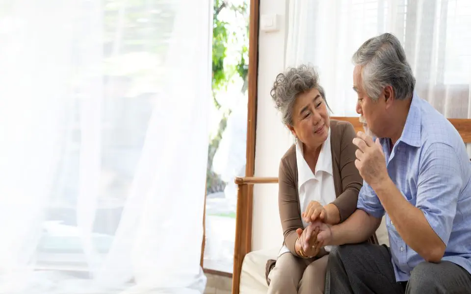 Woman comforting a man on a bench