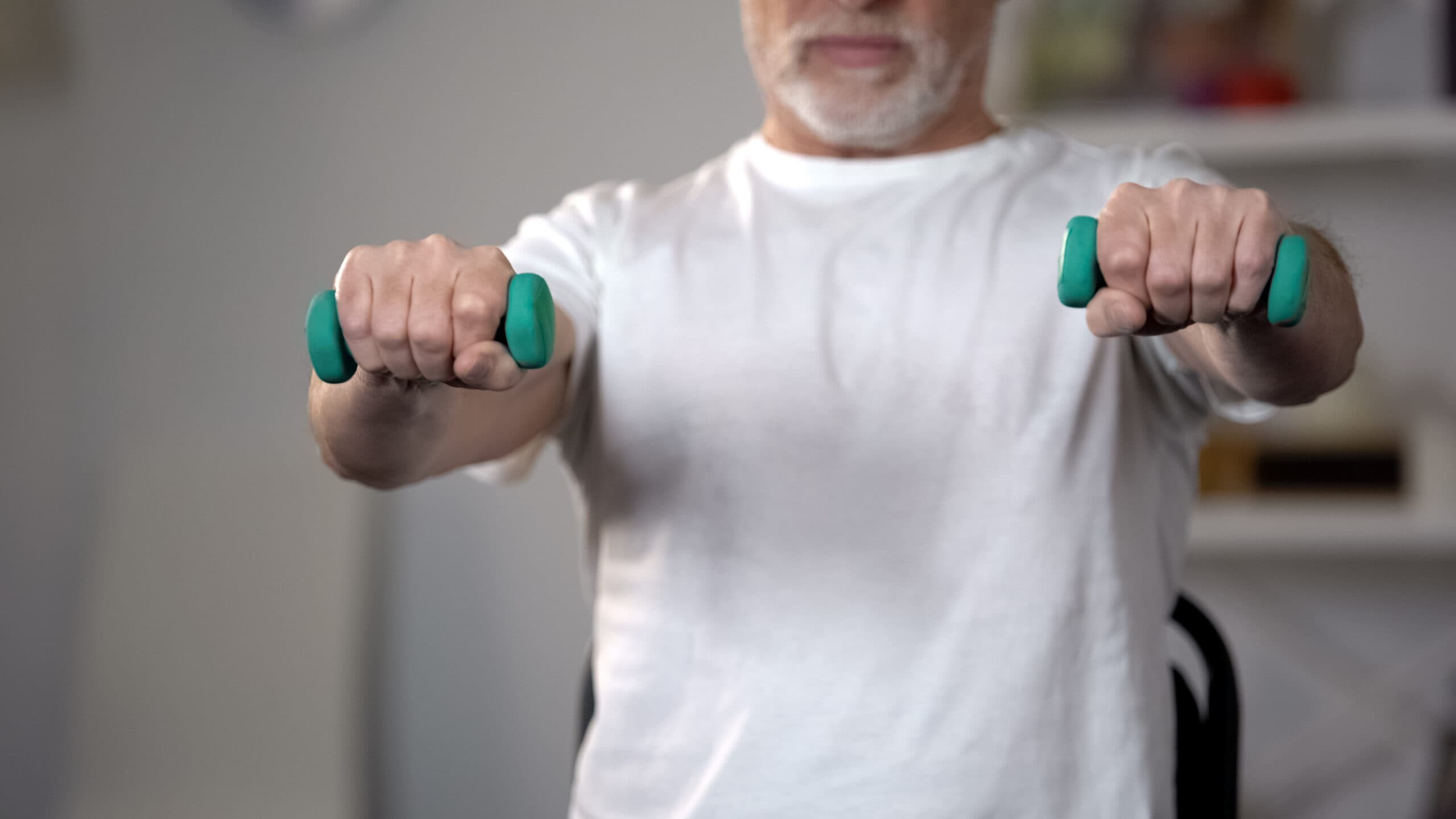 a man lifting two dumb bells