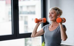 senior woman exercising and lifting dumbbells